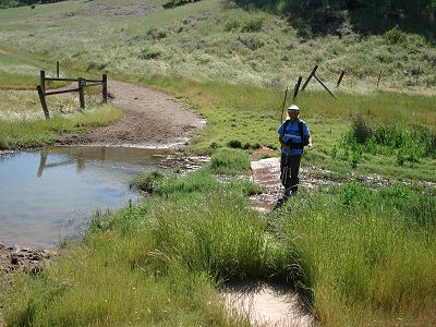 Dinesh negotiating a very wet trail crossing