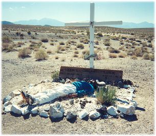 Dinesh pretending to have died atop the roadside gravesite